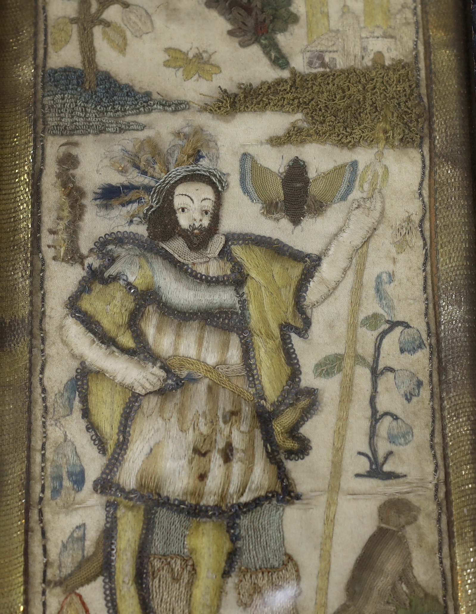 A framed 17th century stumpwork embroidery panel, embroidered with a central figure of a nobleman or king, possibly Henry VIII, holding a staff, wearing a cloth of gold with his dog in the grounds of a castle (possibly N